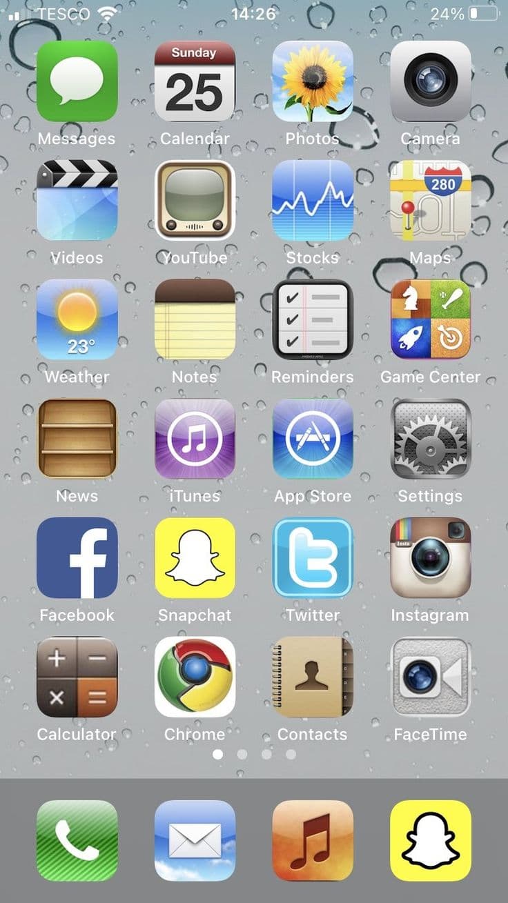 Circa 2014 iPhone home screen with wallpaper showing rain droplets on a blue-gray gradient